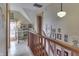 Bright hallway featuring a wood railing, a desk nook and hardwood floors at 37 N Main St, Indianapolis, IN 46227