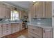 Bright kitchen featuring wood cabinets, light countertops, and a stylish backsplash at 37 N Main St, Indianapolis, IN 46227