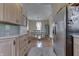 Well-lit kitchen with modern stainless steel appliances and a view into the adjacent dining area at 37 N Main St, Indianapolis, IN 46227