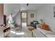 Sunlit living room with hardwood floors, comfortable seating and an open doorway at 37 N Main St, Indianapolis, IN 46227