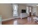 Bright living room with hardwood floors, big windows and large TV at 37 N Main St, Indianapolis, IN 46227