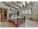 Cozy main bedroom featuring a vaulted ceiling, skylights, and hardwood floors at 37 N Main St, Indianapolis, IN 46227