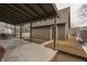 Backyard patio includes covered area, small wooden deck, grill, and landscaped yard at 37 N Main St, Indianapolis, IN 46227