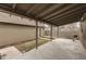 Backyard patio includes covered area, small wooden deck, grill, and landscaped yard at 37 N Main St, Indianapolis, IN 46227