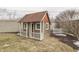 Backyard view of a playhouse on a landscaped yard with a picket fence and mature tree at 37 N Main St, Indianapolis, IN 46227
