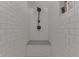 Stylish shower with white tiled walls and a built-in shower bench at 37 N Main St, Indianapolis, IN 46227