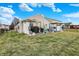 A view of the back of the home with patio, pond and outdoor kitchen at 4318 Ballybay Ln, Indianapolis, IN 46239