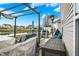 This backyard patio features an outdoor kitchen with a built-in pergola and scenic views of a small pond at 4318 Ballybay Ln, Indianapolis, IN 46239