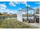 This backyard patio has outdoor kitchen space with seating next to pond at 4318 Ballybay Ln, Indianapolis, IN 46239