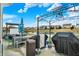 This backyard patio offers an outdoor kitchen area, complete with a pergola, overlooking the water at 4318 Ballybay Ln, Indianapolis, IN 46239