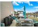 This backyard patio with a seating area has a built-in outdoor kitchen overlooking a pond at 4318 Ballybay Ln, Indianapolis, IN 46239