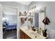 Bathroom featuring double sinks, vanity, medicine cabinet, and doorway to bedroom at 4318 Ballybay Ln, Indianapolis, IN 46239