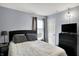 Bedroom showcasing a bed, modern lighting, and a sleek black dresser at 4318 Ballybay Ln, Indianapolis, IN 46239