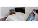 Comfortable bedroom with a padded headboard and chair at 4318 Ballybay Ln, Indianapolis, IN 46239