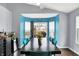 Dining room with wood table, blue chairs, and sliding glass doors letting in ample natural light at 4318 Ballybay Ln, Indianapolis, IN 46239
