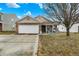 Charming single-story brick home with an attached two-car garage and inviting front porch at 4318 Ballybay Ln, Indianapolis, IN 46239