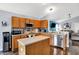 Kitchen with stainless steel appliances, island, tile backsplash, and wood cabinets at 4318 Ballybay Ln, Indianapolis, IN 46239
