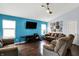 Cozy living room with blue accent wall, fan, hardwood floors, and ample seating at 4318 Ballybay Ln, Indianapolis, IN 46239
