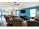 Vibrant living room featuring an accent wall, ceiling fan, and plenty of seating at 4318 Ballybay Ln, Indianapolis, IN 46239