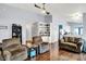 Open-concept living room with hardwood floors, neutral walls, ceiling fan, and plenty of seating at 4318 Ballybay Ln, Indianapolis, IN 46239
