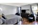 Bedroom featuring a large bed with wood laminate floors, and gray walls at 4318 Ballybay Ln, Indianapolis, IN 46239
