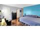 Bedroom featuring a large bed, dark wood laminate floors, and closet at 4318 Ballybay Ln, Indianapolis, IN 46239