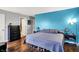 Bedroom featuring a large bed with wood laminate floors and natural light at 4318 Ballybay Ln, Indianapolis, IN 46239