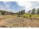 Large backyard with a barn, trees, and a gravel area, offering a rural and spacious outdoor environment at 4533 W 600 N, Fairland, IN 46126