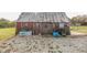 Rustic barn with sliding door, window, and weathered exterior sits on a gravel bed adding to the farm's charm at 4533 W 600 N, Fairland, IN 46126