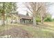 Charming home exterior with stone accents, covered porch, and mature trees offers a serene and inviting curb appeal at 4533 W 600 N, Fairland, IN 46126