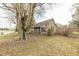 Stone clad home with covered porch and mature trees offers a charming and inviting curb appeal at 4533 W 600 N, Fairland, IN 46126