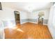Open living room featuring hardwood floors, an elegant chandelier, and arched doorways to other rooms at 4533 W 600 N, Fairland, IN 46126
