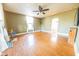 Inviting living room featuring hardwood floors, a ceiling fan, and an archway to the kitchen at 4533 W 600 N, Fairland, IN 46126