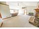 Spacious living room featuring a stone fireplace, neutral carpet, and high ceilings at 4533 W 600 N, Fairland, IN 46126