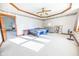 Spacious bedroom featuring carpet, a ceiling fan, and tray ceiling with decorative trim at 4533 W 600 N, Fairland, IN 46126