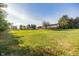 Scenic property showcasing a sprawling lawn, verdant trees, and a picturesque building against a clear sky at 4533 W 600 N, Fairland, IN 46126