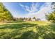 Expansive property featuring lush greenery, mature trees, and a charming barn under a beautiful sky at 4533 W 600 N, Fairland, IN 46126