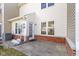 Cozy back patio featuring white siding and a red brick foundation, perfect for outdoor relaxation and entertaining at 459 Dekalb Dr, Westfield, IN 46074