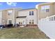 Spacious backyard with a white fence and lush green grass, providing privacy and room for recreation at 459 Dekalb Dr, Westfield, IN 46074