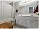 Bright bathroom with dual vanity, white cabinets, and shower-tub combination at 459 Dekalb Dr, Westfield, IN 46074