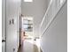 Bright entryway featuring hardwood floors, white staircase, and a glimpse of the exterior through the open door at 459 Dekalb Dr, Westfield, IN 46074