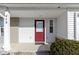 Close up of a red front door with sidelight, covered porch, and white siding at 459 Dekalb Dr, Westfield, IN 46074