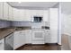 Efficient kitchen featuring white appliances, white cabinets, and hardwood flooring at 459 Dekalb Dr, Westfield, IN 46074