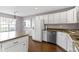 Well-lit kitchen with white cabinetry, stainless steel appliances, and hardwood floors at 459 Dekalb Dr, Westfield, IN 46074