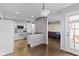 This open-concept kitchen features a breakfast bar, white appliances, and access to the dining and living areas at 459 Dekalb Dr, Westfield, IN 46074