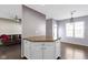 Open-concept kitchen area with hardwood floors, white cabinetry, and modern lighting at 459 Dekalb Dr, Westfield, IN 46074