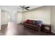 Spacious living room featuring hardwood floors, a ceiling fan, and a comfortable brown leather couch at 459 Dekalb Dr, Westfield, IN 46074