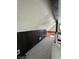 Unique attic space with carpet floors, dark wood paneling, black ceiling beam, and railing at 4953 Mccray St, Indianapolis, IN 46224