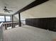 Attic space with carpet, black ceiling beams, railing, and a window that provides natural light at 4953 Mccray St, Indianapolis, IN 46224