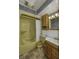 Full bathroom with a tub, vanity, mirror and decorative floral wallpaper at 4953 Mccray St, Indianapolis, IN 46224